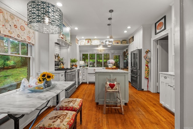 445 Midland St, Little Rock, AR 72205 - kitchen featuring high end appliances, a center island, plenty of natural light, light wood-style floors, and recessed lighting