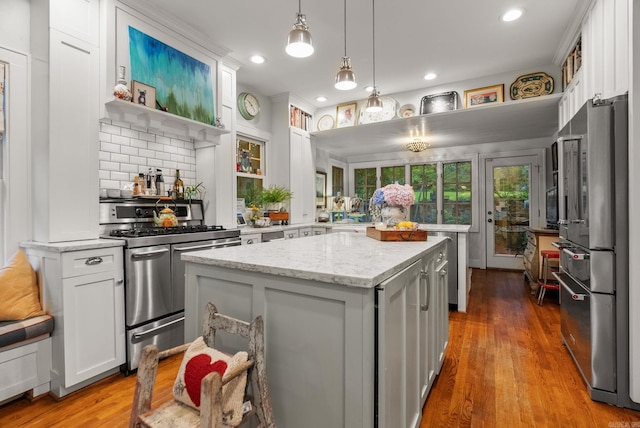445 Midland St, Little Rock, AR 72205 - kitchen featuring appliances with stainless steel finishes, a center island, white cabinets, light stone counters, and recessed lighting