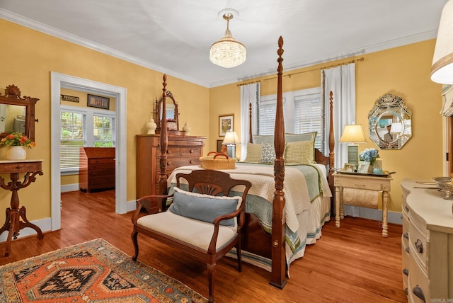 445 Midland St, Little Rock, AR 72205 - bedroom with crown molding, wood finished floors, and a chandelier
