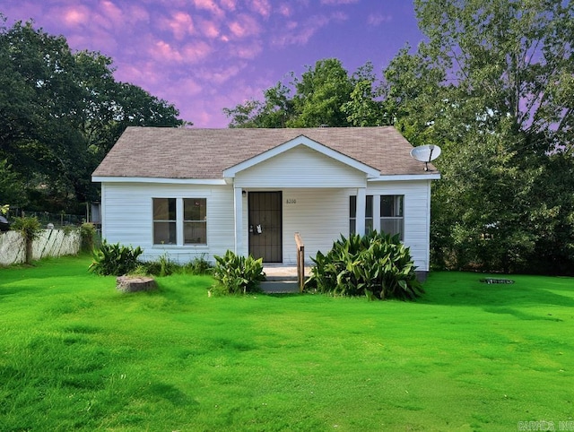 8200 W 34th St, Little Rock, AR 72204 - bungalow-style home featuring a lawn and a shingled roof