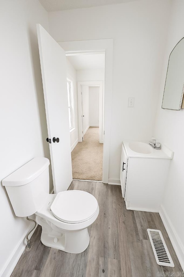 8200 W 34th St, Little Rock, AR 72204 - half bathroom featuring wood finished floors and vanity