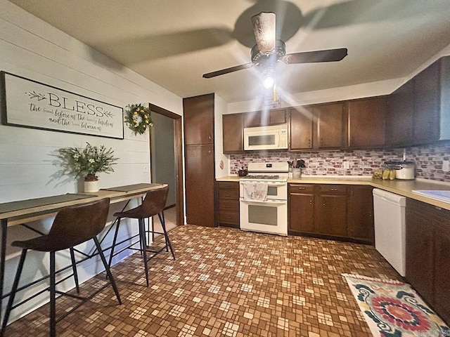 203 Richwood Dr, Mountain Home, AR 72653 - kitchen featuring white appliances, ceiling fan, light countertops, tasteful backsplash, and wooden walls