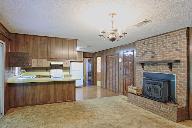 6 Elaine Rd, Sheridan, AR 72150 - kitchen featuring white appliances, wooden walls, range hood, a chandelier, and carpet floors