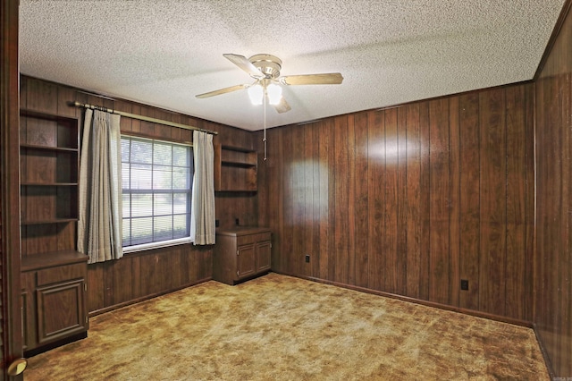 6 Elaine Rd, Sheridan, AR 72150 - carpeted spare room featuring wood walls, a ceiling fan, and a textured ceiling