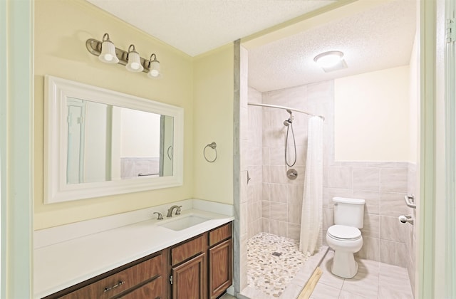 6 Elaine Rd, Sheridan, AR 72150 - bathroom featuring vanity, a textured ceiling, tiled shower, tile patterned flooring, and tile walls