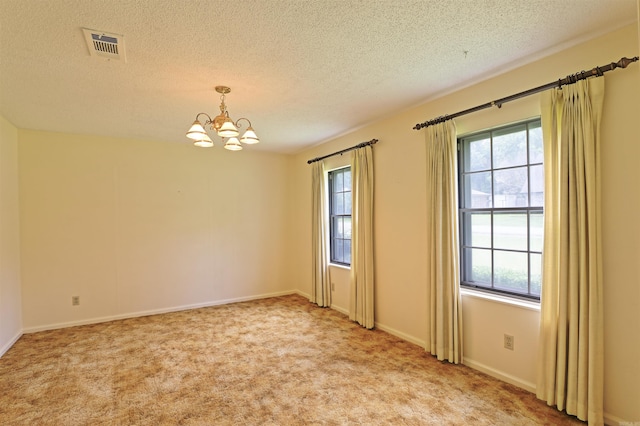 6 Elaine Rd, Sheridan, AR 72150 - empty room with a chandelier, a textured ceiling, and carpet floors
