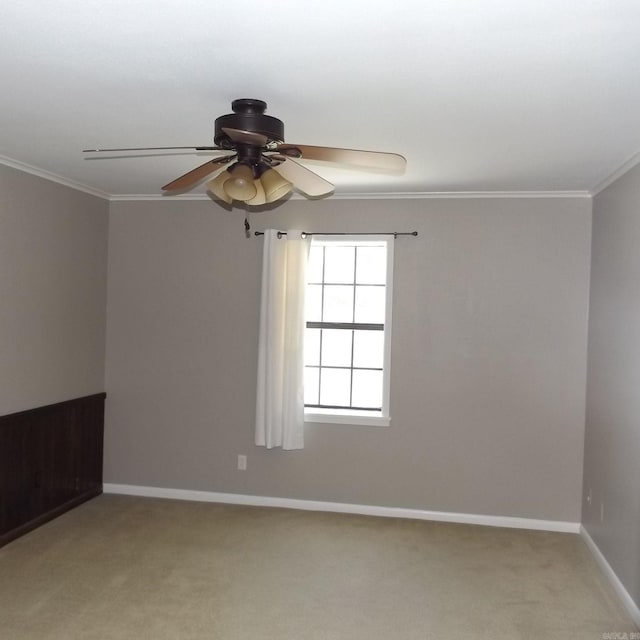 unfurnished room featuring ornamental molding, a ceiling fan, and light carpet