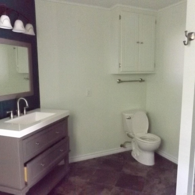 bathroom featuring baseboards and vanity