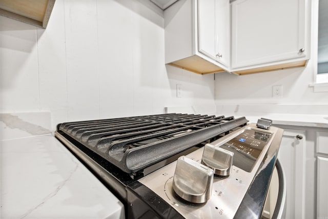 10301 Milkyway Dr, Little Rock, AR 72209 - kitchen view of stainless steel gas range and white cabinetry