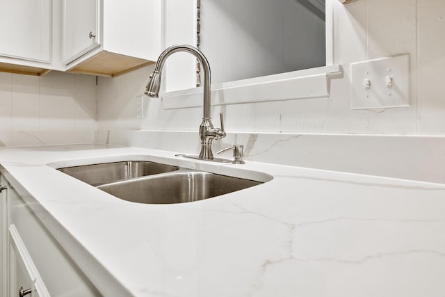 10301 Milkyway Dr, Little Rock, AR 72209 - kitchen view of white cabinetry, decorative backsplash, and light stone countertops
