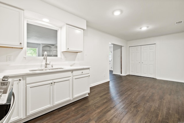 10301 Milkyway Dr, Little Rock, AR 72209 - kitchen with white cabinetry, dark wood-type flooring, light countertops, stainless steel range oven, and recessed lighting