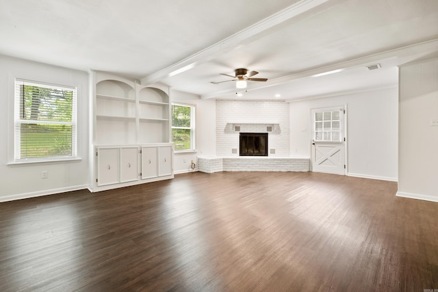 10301 Milkyway Dr, Little Rock, AR 72209 - unfurnished living room featuring ceiling fan, dark wood-style floors, beam ceiling, and a brick fireplace