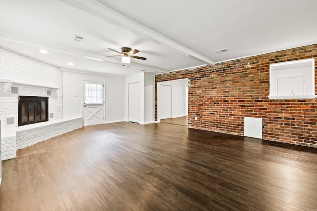 10301 Milkyway Dr, Little Rock, AR 72209 - unfurnished living room with a ceiling fan, wood finished floors, a fireplace, brick wall, and beamed ceiling