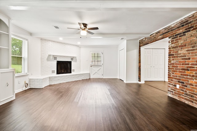 10301 Milkyway Dr, Little Rock, AR 72209 - unfurnished living room with ceiling fan, wood finished floors, healthy amount of natural light, a fireplace, and brick wall