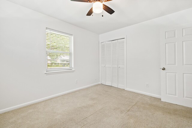 10301 Milkyway Dr, Little Rock, AR 72209 - unfurnished bedroom featuring light colored carpet, a closet, and a ceiling fan