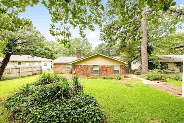 10301 Milkyway Dr, Little Rock, AR 72209 - rear view of property featuring brick siding and a chimney