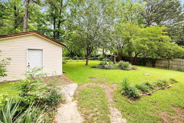 10301 Milkyway Dr, Little Rock, AR 72209 - fenced backyard featuring an outdoor structure and view of wooded area