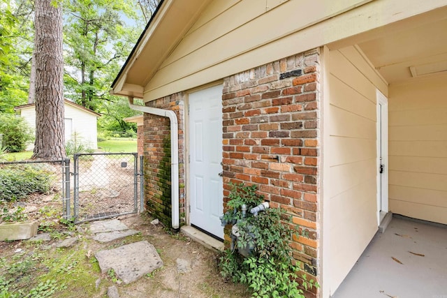 10301 Milkyway Dr, Little Rock, AR 72209 - doorway to property featuring brick siding and a gate