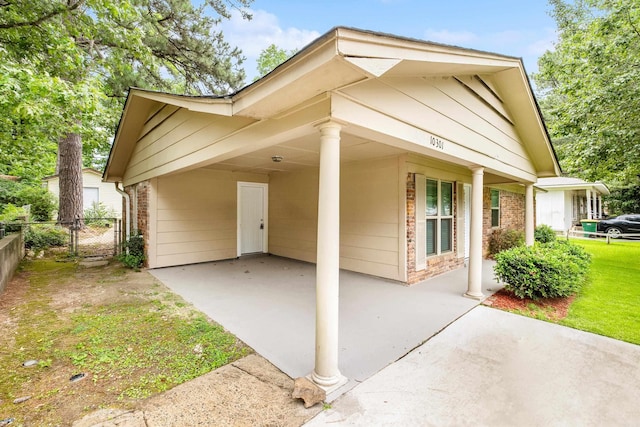 10301 Milkyway Dr, Little Rock, AR 72209 - view of front of property with a carport, concrete driveway, brick siding, and a gate