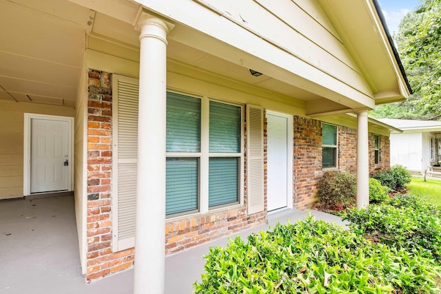10301 Milkyway Dr, Little Rock, AR 72209 - doorway to property with brick siding and covered porch