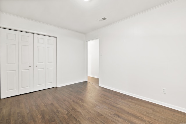 10301 Milkyway Dr, Little Rock, AR 72209 - unfurnished bedroom with crown molding, wood finished floors, and a closet