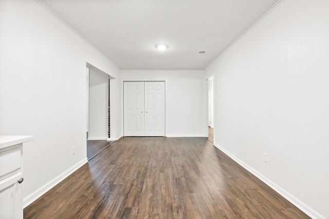 10301 Milkyway Dr, Little Rock, AR 72209 - unfurnished bedroom featuring ornamental molding, dark wood-style flooring, and a closet