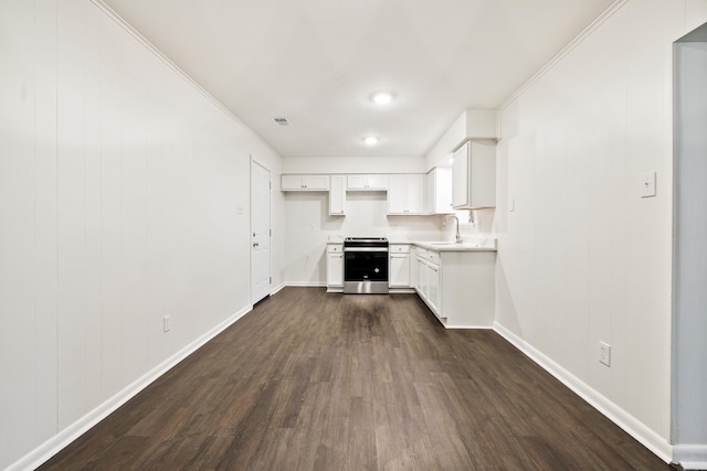 10301 Milkyway Dr, Little Rock, AR 72209 - kitchen with electric range, dark wood-style flooring, white cabinets, light countertops, and ornamental molding