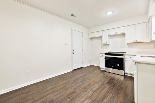 10301 Milkyway Dr, Little Rock, AR 72209 - kitchen with electric range, dark wood-style floors, light countertops, and white cabinetry