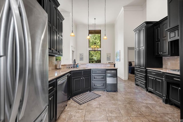 909 Nature Way, Benton, AR 72019 - kitchen featuring appliances with stainless steel finishes, ornamental molding, a high ceiling, tasteful backsplash, and dark cabinetry