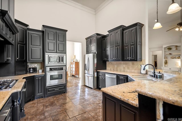 909 Nature Way, Benton, AR 72019 - kitchen featuring appliances with stainless steel finishes, a towering ceiling, crown molding, ceiling fan, and tasteful backsplash