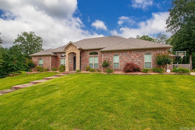 909 Nature Way, Benton, AR 72019 - french country style house featuring brick siding, a front yard, and a shingled roof