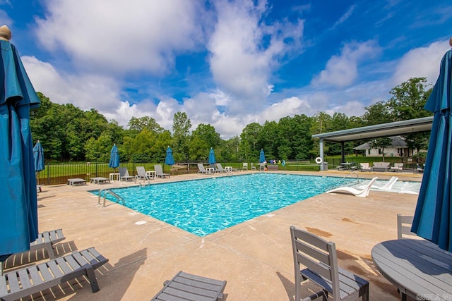 909 Nature Way, Benton, AR 72019 - community pool featuring a patio and view of wooded area