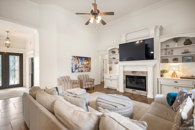 909 Nature Way, Benton, AR 72019 - tiled living area featuring ceiling fan, a fireplace, ornamental molding, french doors, and a high ceiling