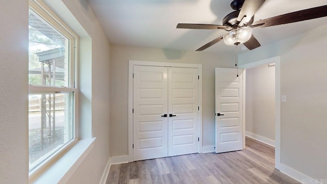 181/2 Woodlawn, Conway, AR 72034 - unfurnished bedroom with wood finished floors, a closet, multiple windows, and ceiling fan