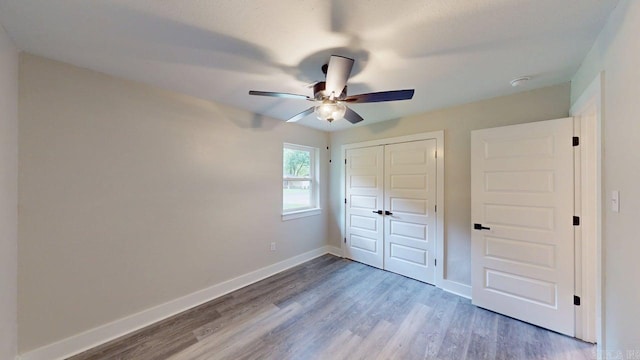 181/2 Woodlawn, Conway, AR 72034 - unfurnished bedroom featuring wood finished floors, a closet, and a ceiling fan