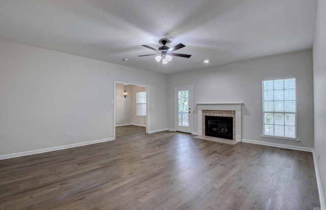 12825 Westglen Dr, Little Rock, AR 72211 - unfurnished living room featuring a ceiling fan, dark wood-style flooring, and a tile fireplace