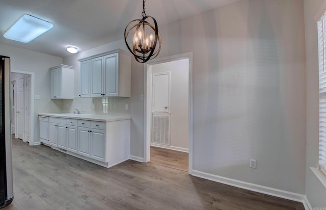 12825 Westglen Dr, Little Rock, AR 72211 - kitchen featuring a chandelier, light wood-type flooring, white dishwasher, light countertops, and pendant lighting