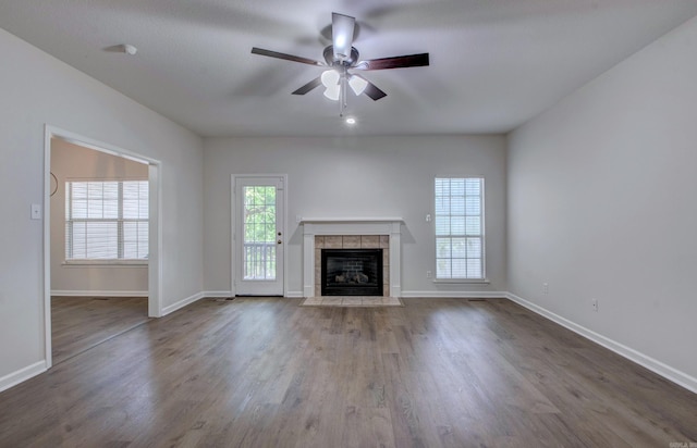 12825 Westglen Dr, Little Rock, AR 72211 - unfurnished living room featuring ceiling fan, a tile fireplace, and wood finished floors