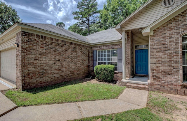 12825 Westglen Dr, Little Rock, AR 72211 - doorway to property featuring brick siding, an attached garage, and a lawn