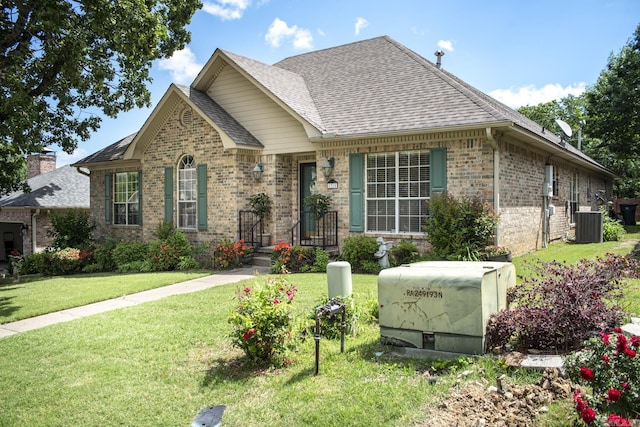 1315 Gleneagles Ct, Little Rock, AR 72211 - view of front of house with brick siding, a shingled roof, and a front yard