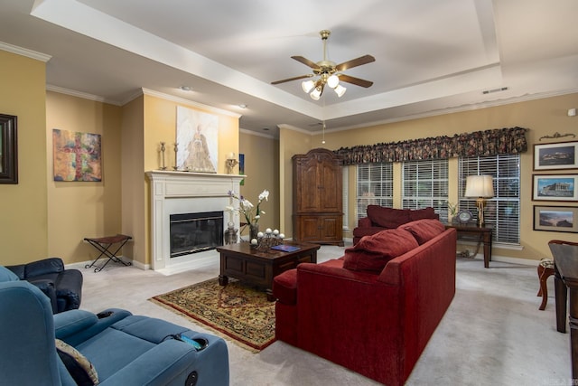 1315 Gleneagles Ct, Little Rock, AR 72211 - living area with a tray ceiling, light carpet, a glass covered fireplace, ceiling fan, and crown molding