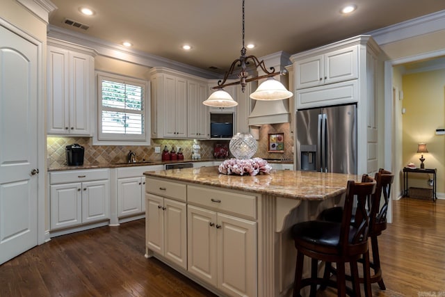 103 Falata Cir, Little Rock, AR 72223 - kitchen with appliances with stainless steel finishes, ornamental molding, a kitchen island, dark wood-style flooring, and decorative backsplash