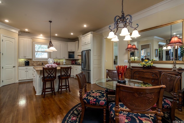 103 Falata Cir, Little Rock, AR 72223 - dining space featuring a chandelier, crown molding, dark wood-style flooring, and recessed lighting