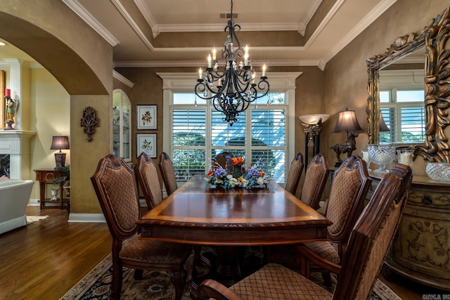 103 Falata Cir, Little Rock, AR 72223 - dining area with a chandelier, wood finished floors, healthy amount of natural light, arched walkways, and crown molding