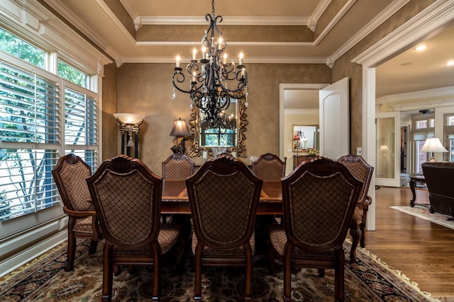 103 Falata Cir, Little Rock, AR 72223 - dining room featuring a chandelier, wood finished floors, a raised ceiling, and ornamental molding
