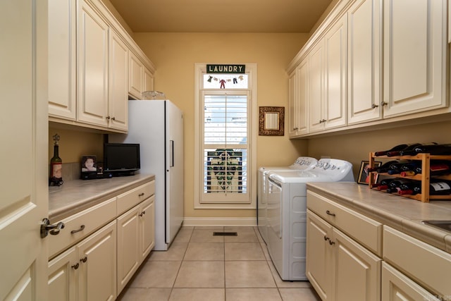 103 Falata Cir, Little Rock, AR 72223 - laundry room featuring cabinet space, separate washer and dryer, and light tile patterned floors
