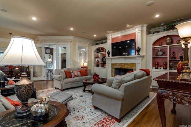 103 Falata Cir, Little Rock, AR 72223 - living room with crown molding, wood finished floors, a high end fireplace, built in shelves, and recessed lighting