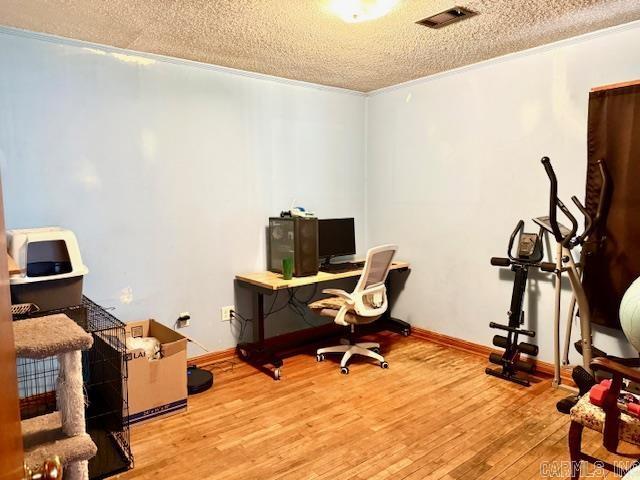 119 N 20th St, Arkadelphia, AR 71923 - home office featuring a textured ceiling and wood finished floors