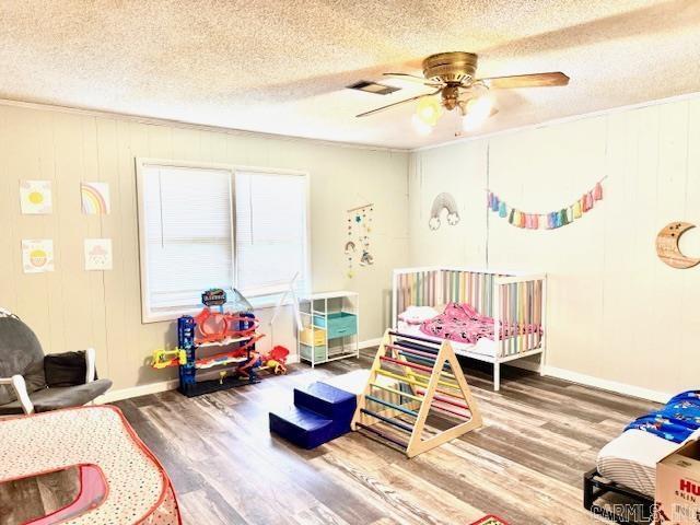119 N 20th St, Arkadelphia, AR 71923 - bedroom featuring a textured ceiling, wood finished floors, ceiling fan, and ornamental molding