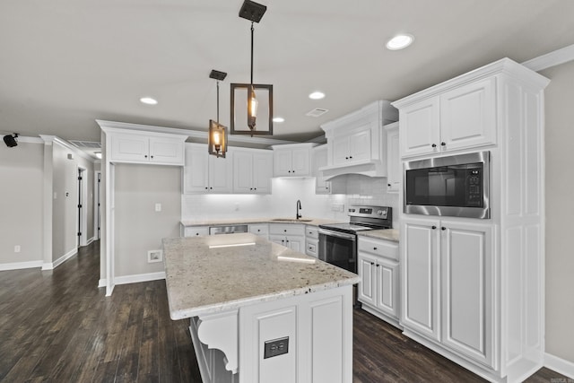 36 Fletcher Dr, Austin, AR 72007 - kitchen featuring stainless steel appliances, a center island, white cabinets, decorative backsplash, and recessed lighting